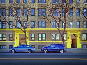 Yellow building highlights and blue cars